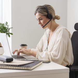 medium shot woman sitting desk min